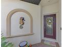 Front entry with decorative seahorse and wreath at 9847 Haze Dr, Venice, FL 34292