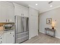 Stainless steel appliances and white cabinets in kitchen at 9855 Haze Dr, Venice, FL 34292