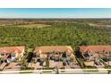 Aerial view of a townhome community with lush landscaping at 10055 Crooked Creek Dr # 102, Venice, FL 34293