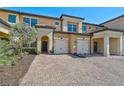 Front view of townhome with landscaping and paver driveway at 10055 Crooked Creek Dr # 102, Venice, FL 34293