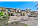 Luxury townhome with paver driveway and two-car garage at 10055 Crooked Creek Dr # 102, Venice, FL 34293