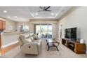 Spacious living room with a comfortable sofa and access to the patio at 115 Avalini Way, North Venice, FL 34275