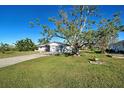 House with mature tree and a spacious lawn at 1358 Leawood Rd, Englewood, FL 34223