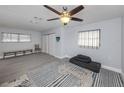 Bright bedroom with gray walls, tile floor, and a ceiling fan at 1363 Brookside Dr, Venice, FL 34285