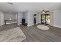 Open living room with gray floors, modern furniture, and pool view at 1363 Brookside Dr, Venice, FL 34285