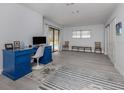 Home office featuring a blue desk, tile floor, and view of the pool at 1363 Brookside Dr, Venice, FL 34285