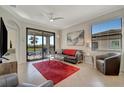 Comfortable living room with sliding doors leading to a balcony at 17108 Vardon Ter # 308, Bradenton, FL 34211