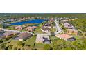 Community overview featuring a tranquil lake and numerous homes at 19718 Cobblestone Cir, Venice, FL 34292