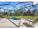 Relaxing screened-in pool and spa with lounge chairs at 19718 Cobblestone Cir, Venice, FL 34292