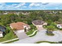 Two houses in a residential neighborhood with lush trees and a pond at 20909 Duomo Ct, Venice, FL 34293