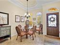 Charming dining area featuring a glass table, seating for four, and natural light from large windows at 305 Rio Terra, Venice, FL 34285