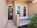 Inviting front entry with decorative door and sidelights at 305 Rio Terra, Venice, FL 34285