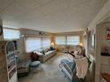 Cozy living room featuring wicker furniture and a comfortable seating area at 611 50Th Avenue W Dr, Bradenton, FL 34207