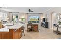Open concept kitchen with island, white countertops, and wooden cabinets at 9607 Sea Turtle Ter # 101, Bradenton, FL 34212