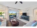 Spacious living room with patio access and view of the water at 9607 Sea Turtle Ter # 101, Bradenton, FL 34212