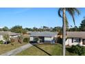 Cute single story home with a spacious yard and a palm tree at 1040 Hope St, Venice, FL 34285