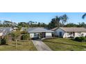 Quaint light teal single-story house with a fenced backyard at 1040 Hope St, Venice, FL 34285