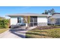 Newly renovated light teal single story home with a screened porch at 1040 Hope St, Venice, FL 34285