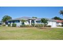 House exterior with two-car garage and lush landscaping at 108 Hourglass Dr, Venice, FL 34293