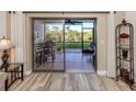 Living room with view of patio and water at 1100 Capri Isles Blvd # 212, Venice, FL 34292