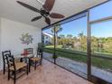 Bright screened patio with table and chairs, water view at 1100 Capri Isles Blvd # 212, Venice, FL 34292