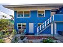 Blue house with brick pathway, and nicely landscaped yard at 113 Colonia W Ln, Nokomis, FL 34275