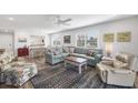 Open-concept living room with a cozy seating area and adjacent dining space at 1200 Tarpon Center Dr # 108, Venice, FL 34285