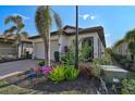 House exterior showcasing landscaping and a two-car garage at 125 Soliera St, Nokomis, FL 34275