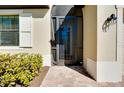 Front entry with decorative screen door and brick walkway at 12704 Richezza Dr, Venice, FL 34293