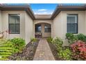 Brick walkway leading to a covered entry with seating area at 12837 Oriago St, Venice, FL 34293