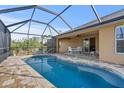 Inviting screened-in pool and patio with seating area at 13156 Dodds Ct, Port Charlotte, FL 33953