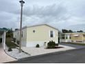 Front view of a yellow mobile home at 223 Roma Rd, Venice, FL 34285