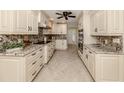 Modern kitchen with granite countertops and white cabinets at 2269 Lakewood Dr, Nokomis, FL 34275