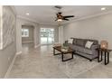 Spacious living room with grey sofa and access to a patio at 2269 Lakewood Dr, Nokomis, FL 34275