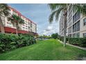 Landscaped grounds with lush greenery between two apartment buildings at 232 Saint Augustine Ave # 404, Venice, FL 34285