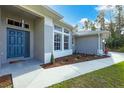 Welcoming front entrance with teal door and landscaping at 3328 Waterloo Ter, North Port, FL 34286