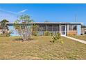Blue ranch home with a screened porch at 370 Waltham St, Port Charlotte, FL 33952