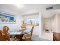 Dining area with kitchen pass-through and view to entry at 404 Cerromar N Cir # 116, Venice, FL 34293