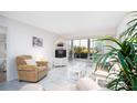 Bright living room with comfy furniture and view to patio at 404 Cerromar N Cir # 116, Venice, FL 34293