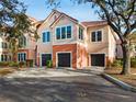 Two-story townhome with two-car garage and mature landscaping at 4110 Central Sarasota Pkwy # 127, Sarasota, FL 34238