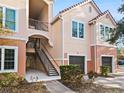 Townhome exterior showcasing staircase and two-car garage at 4110 Central Sarasota Pkwy # 127, Sarasota, FL 34238