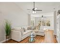 Bright living room with sectional sofa, hardwood floors, and large windows at 4110 Central Sarasota Pkwy # 127, Sarasota, FL 34238