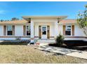 Front view of a single story house with a covered entryway at 5045 Pompano Rd, Venice, FL 34293