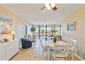 Open living space featuring a dining table, seating area, and balcony access at 612 Bird Bay S Dr # 309, Venice, FL 34285