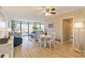 Bright living room with light flooring, comfy seating, and a dining area at 612 Bird Bay S Dr # 309, Venice, FL 34285