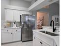 White kitchen features stainless steel appliances and quartz countertops at 624 Silk Oak Dr, Venice, FL 34293