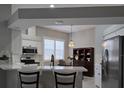 Bright kitchen with white cabinets, stainless steel appliances, and quartz countertops at 624 Silk Oak Dr, Venice, FL 34293