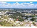 Sprawling aerial view of a residential neighborhood with lush greenery and nearby highway access at 6502 Whelan St, Englewood, FL 34224