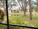 Peaceful view of a pond and lush greenery from a condo at 654 Bird Bay E Dr # 106, Venice, FL 34285