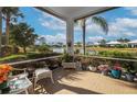 Relaxing screened patio with lake view and comfortable seating at 655 Crossfield Cir # 7, Venice, FL 34293